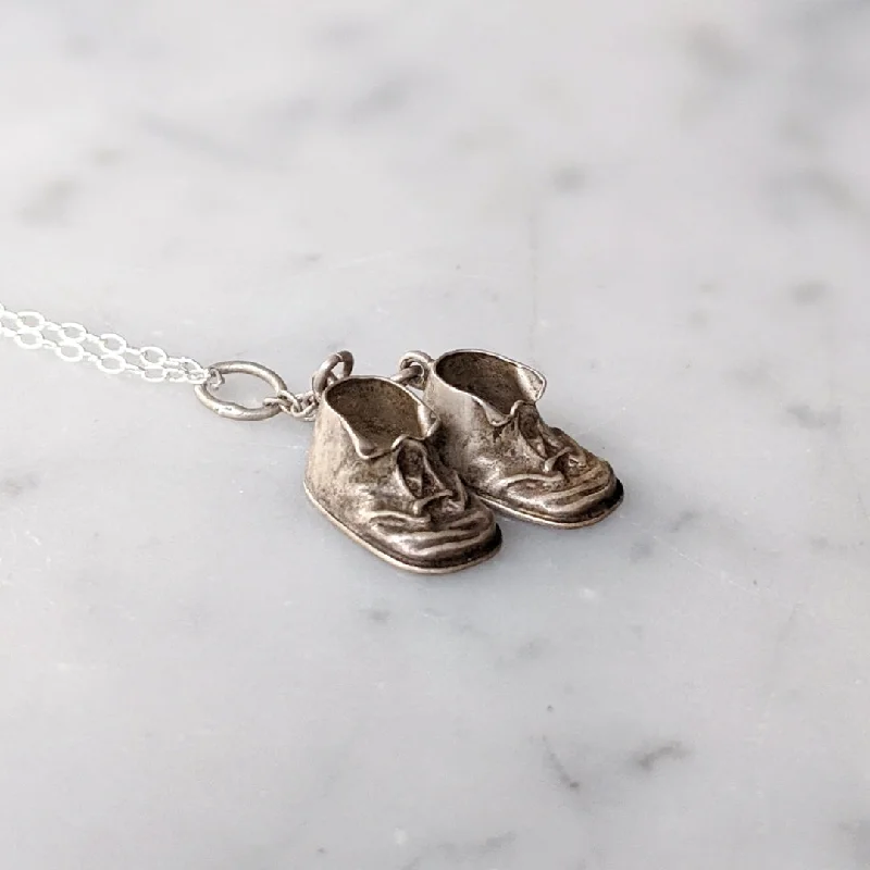 Best necklaces and pendants with intricate beadwork for a bohemian-inspired look-Necklaces with engraved coordinates for travel lovers -Antique Baby Booties Necklace